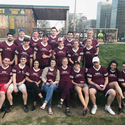 Image of a softball team posing for a team photo.